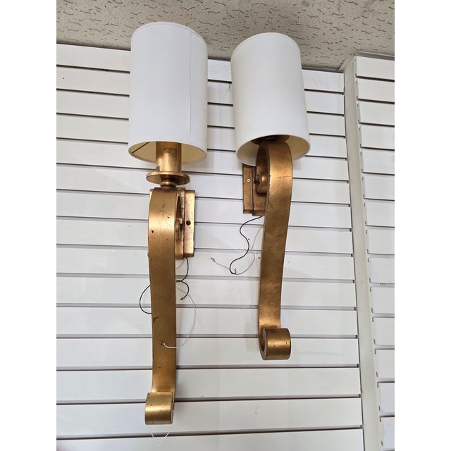 Fine Arts handcrafted lighting. Features a dramatic curved metal arm in a gold leaf finish. A single light fixture with a...