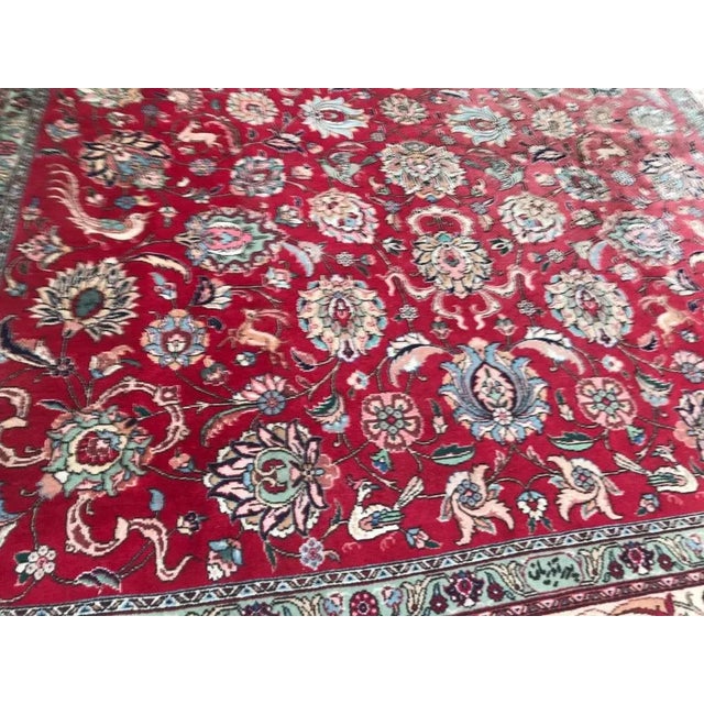 Very beautiful large rug with a nice decorative design and red field color with green, orange and blue. Entirely hand...