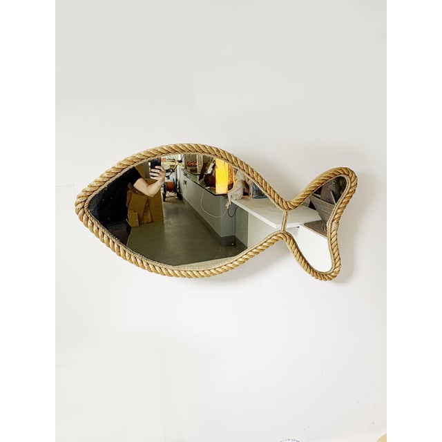 Charming French wall mirror dating from the 1960s, featuring an unusual fish-shaped silhouette. The mirror is entirely...