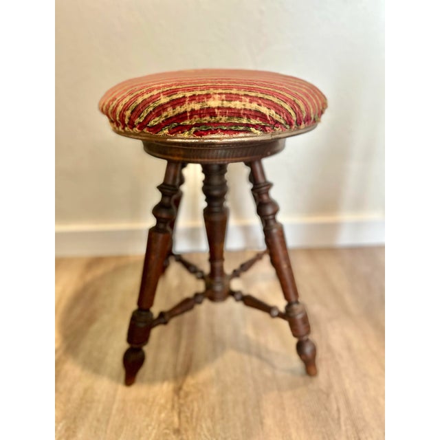An exceptional antique English oak and upholstered stool. Hand turned legs. Beautifully worn upholstered top. Sturdy and...
