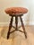 An exceptional antique English oak and upholstered stool. Hand turned legs. Beautifully worn upholstered top. Sturdy and...