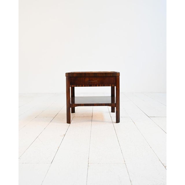 Coffee table with inlaid top, front drawer, and lower shelf. European production, 1930s. Art Deco coffee table from the...