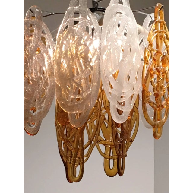 Beautiful atmospheric Vistosi chandelier with in Spaghetti style discs in mouth-blown glass threads, brown and opal. Metal...