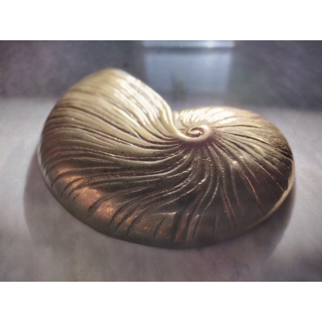 A beautiful vintage brass sea shell wall hanging. This brass wall hanging would make a great standalone gift or work as...