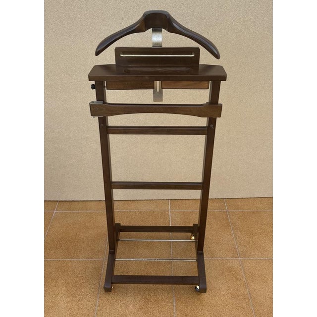 Elegant vintage valet stand, crafted in wood with a clean and practical design. This functional piece features an...