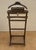 Elegant vintage valet stand, crafted in wood with a clean and practical design. This functional piece features an...