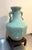 Early 20th-century Chinese celadon porcelain vase w/ elephant head detail at sides and wood stand. Excellent condition....