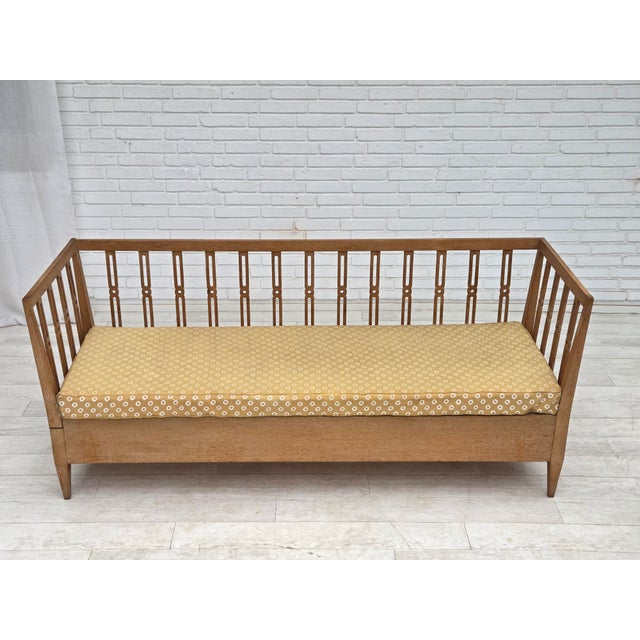 1970s, Swedish drop arm sofa/daybed. Original light yellow furniture fabric, oak wood, springs in the cushion. Original...