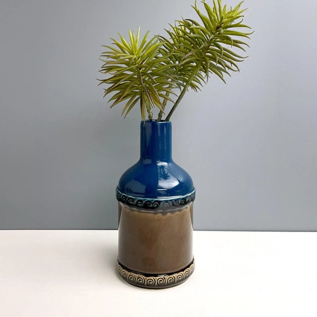 Dark brown and blue porcelain bottle vase from the Brotzeit line, designed by Björn Wiinblad for Rosenthal in the 1970s....