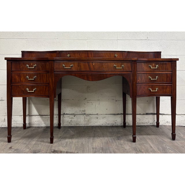 This is an absolutely stunning vintage Federal, Georgian George III, or Hepplewhite style ribbon mahogany serpentine bow...