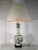 Large lamp formed by a baluster vase on a white background, with polychrome decor, placed on a molded base in blackened...