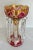Here is a stunning luster made with cut glass vase in ruby/raspberry and amber colors that is adorned with decadent...