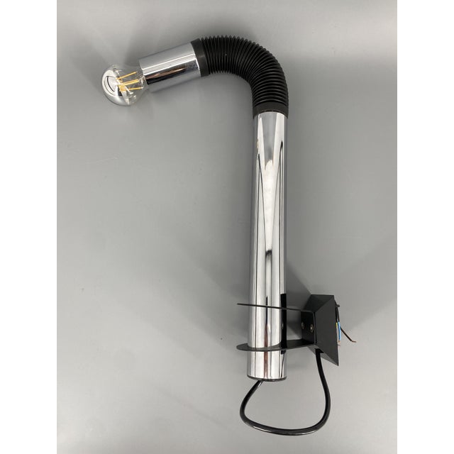 A wall lamp * rare italian design, 1970s * designer e. Bellini for targetti sankey * chrome-plated metal and black rubber...