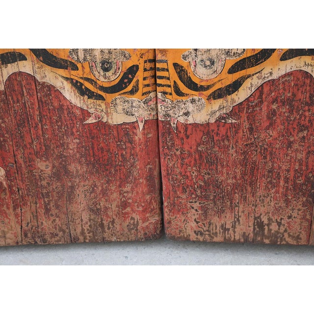 A striking antique Chinese double-panel door, hand-painted with a bold tiger motif and dating to the late Qing dynasty....