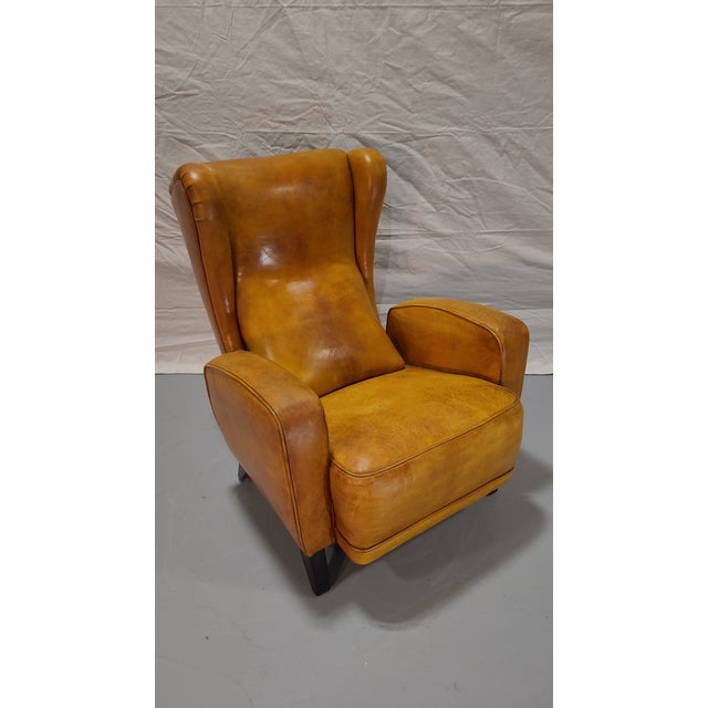 This is a beautiful armchair in the mid-century style of Jean de Merry. Leather is in beautiful condition with a...