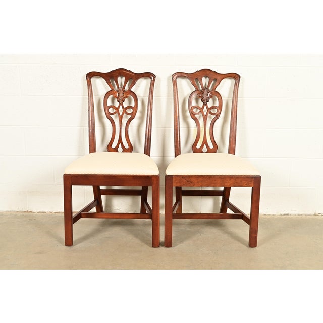 A gorgeous pair of Georgian or Chippendale style side chairs or dining chairs By Henredon USA, Circa 1980s Carved mahogany...
