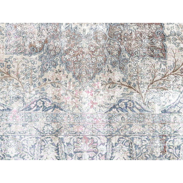This semi-antique Kerman rug exemplifies the refined craftsmanship of Iran's most prestigious weaving center. Hand-woven...