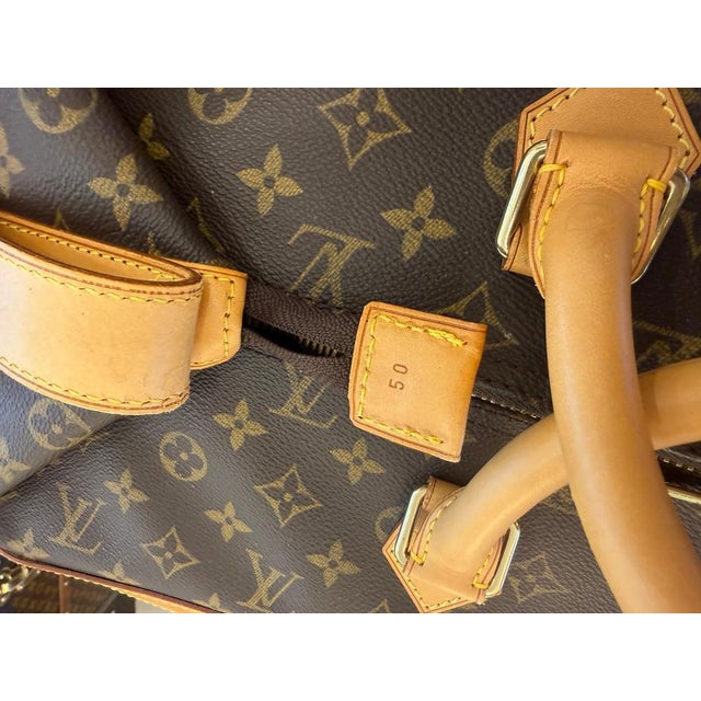 An exceptional louis vuitton travel bag crafted from the house's iconic monogram canvas, with natural calfskin leather...