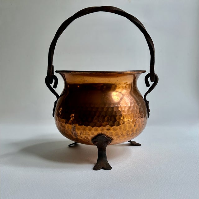 Mid 20th Century footed and handled hand-hammered Copper Cauldron. Planter. Pot. Vase. Featuring a rustic design with urn...