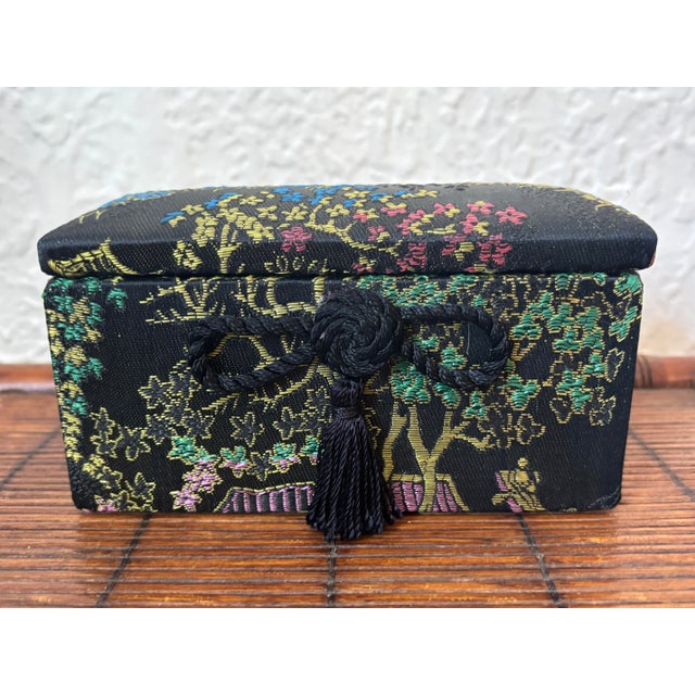 Lovely 1970s vibrant fabric lidded box covered in Japanese landscape motif. The lid hinges open to a black interior....