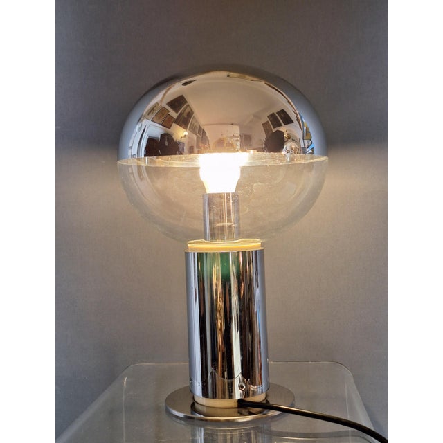 Rare table lamp, model 001391, by Motoko Ishii for Staff Lighting. Mirrored glass shade on a chrome base, 1970s. This...