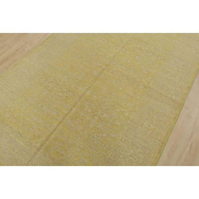 A modern traditional Ziegler rug hand-knotted with fine wool on a cotton foundation. This rug features a subtle botanical...