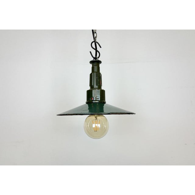 Industrial petrol enamel pendant light made in Poland during the 1960s. White enamel inside the shade. Green cast...