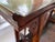 A large and graceful Chinese altar console table with an inverted flange top and straight legs connected by pierced carved...