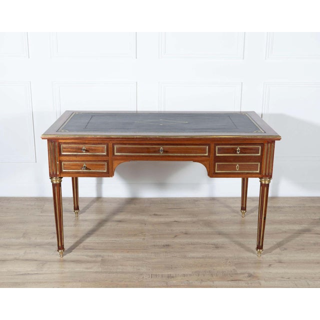 Elegant 19th-century Louis XVI–style mahogany flat desk, double-sided and richly detailed in the refined neoclassical...