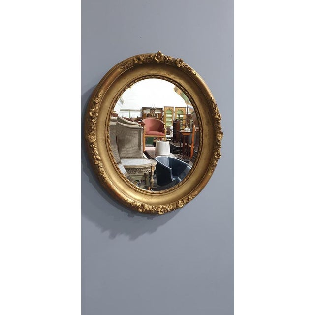 This is a lovely English deep framed oval gilt wall mirror with original plate glass and back boards, in lovely original...
