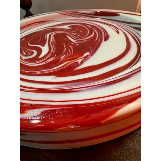 This murano glass bowl and plate, designed by sergio asti for venini in the 1970s, features a swirling pattern in...