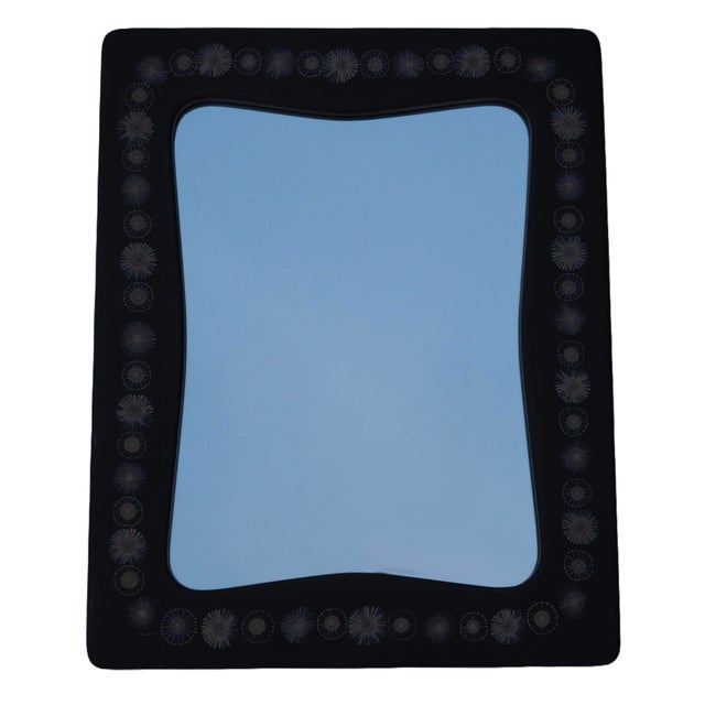 Swedish wall mirror by Hans-Agne Jakobsson, produced in Åhus, Sweden, and dated 1953. This example is distinguished by its...