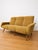 A 1950s three-seater sofa in quintessential Midcentury Modern style, characterized by organic lines and a wraparound...