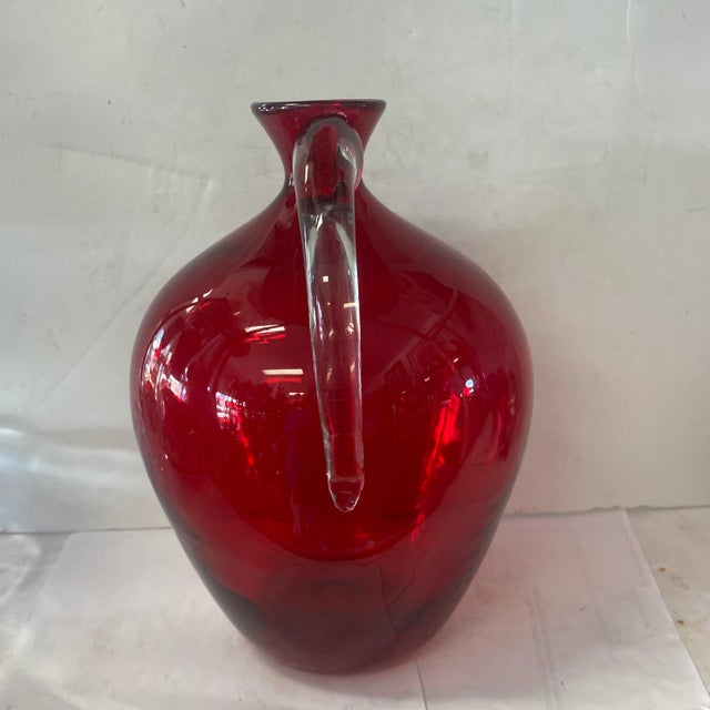 Beautiful Bleno vase that resembles a pitcher in a deep red color. Has a Blenko sticker on the bottom