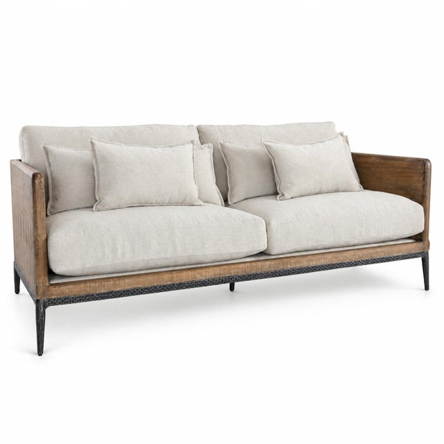 Unique modern sofa with handsome salvaged pine wood frame. Hand hammered iron legs and ivory toned plush cushions. Full...