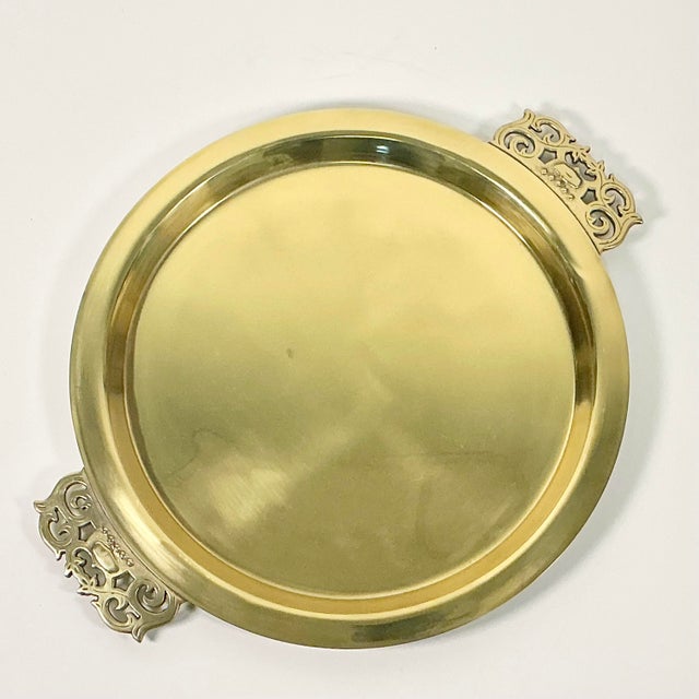 The simplicity of design is the marquee element that makes this Mid-Century Brass Serving Tray so beautiful. It's a round...