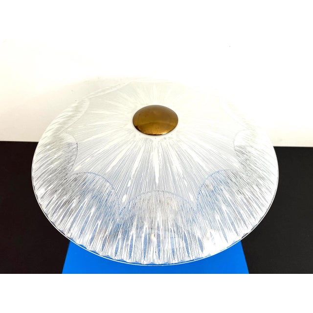 Stunning big mid century atomic ceiling mount chandelier with radiant starburst frosted glass shade suspended above a gold...