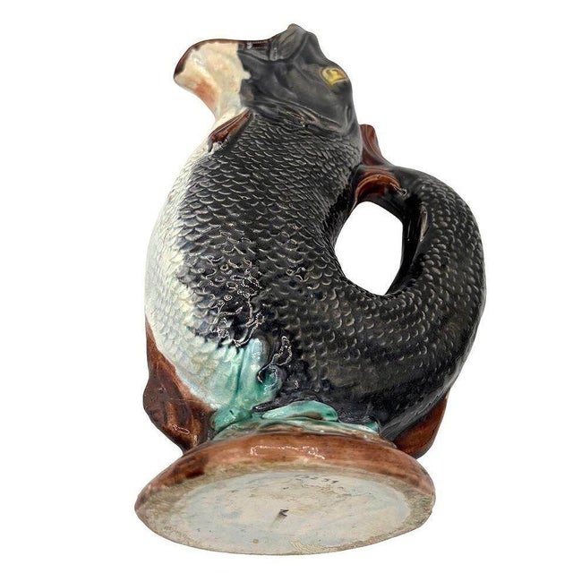 This late 19th-century 1180 English Majolica gurgling trout ceramic jug is a stunning example of late Victorian English...