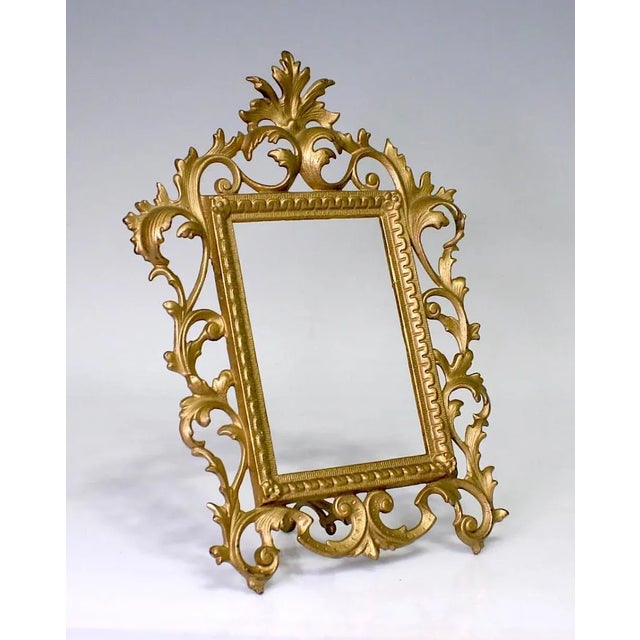 A high quality cast iron frame with a warm gold finish in an elaborate Rococo design. Made for a 4" x 6" portrait /...