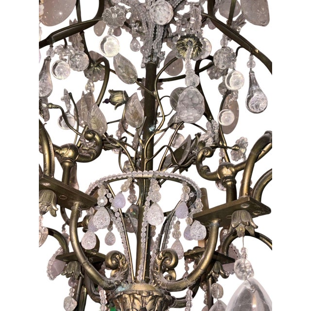 An exceptional French Maison Baguès chandelier, dating to circa 1940s, richly embellished with rock crystal, rose quartz,...