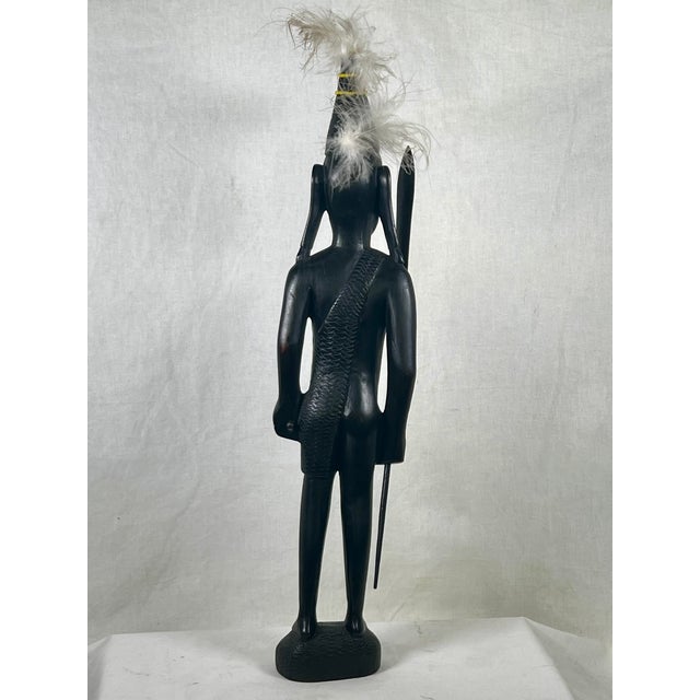 This striking mid-century modern East African warrior sculpture stands an impressive 18.5 inches tall. Masterfully hand-...