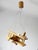 A unique carved pine wood pendant light shaped like a biplane, emblematic of the playful, handcrafted designs of the...