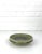 Ceramic vide-poche or low bowl in olive green tones with a subtle blue flame in the center. It comes with a thick glaze....