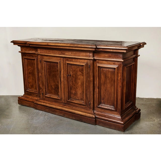 A strong, handsome, completely original walnut buffet from the area of Tuscany. Dramatic carved raised moldings on the...