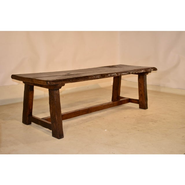 19th century chestnut live edge coffee table from France. The top is made from one thick plank, which has live edges on...