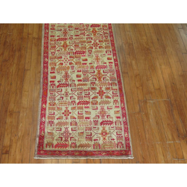 A Turkish runner with predominant accents in red, orange, and ivory from the mid-20th century measures: 2'8" x 10'9"