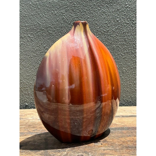 This striking vintage ceramic vase is a quintessential piece of mid-to-late century decor, featuring a sophisticated...