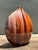 This striking vintage ceramic vase is a quintessential piece of mid-to-late century decor, featuring a sophisticated...