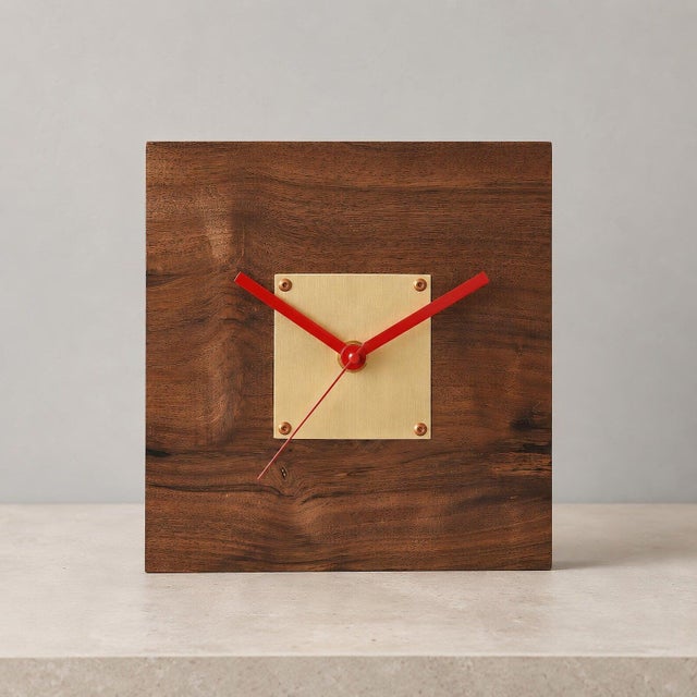 Handmade desk clock crafted from solid walnut with a solid brass center plate. The compact square form, with a 30 mm thick...