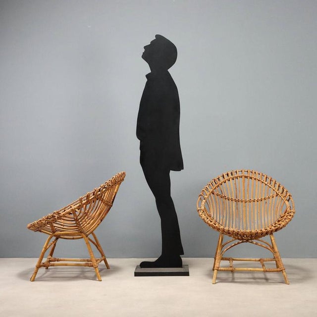 Pair of 1960s bamboo armchairs, featuring a light and airy design typical of the era. The woven bamboo structure offers a...